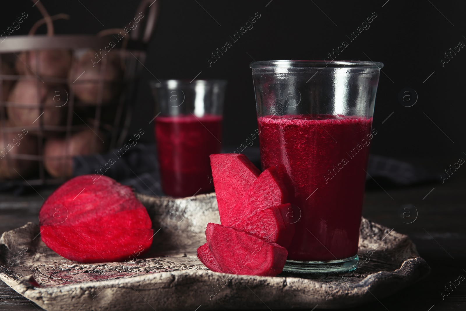 Photo of Plate with glass of beet smoothie on table