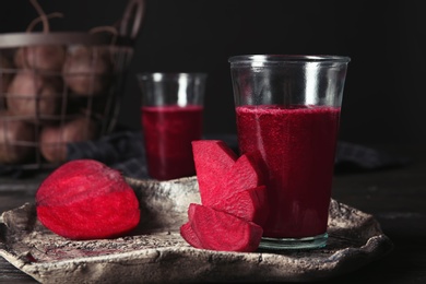 Plate with glass of beet smoothie on table