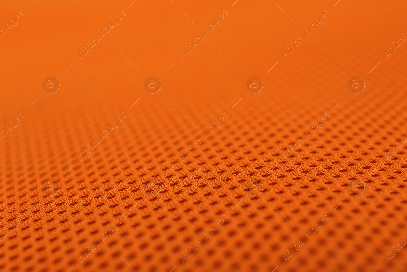 Photo of Texture of orange fabric as background, closeup