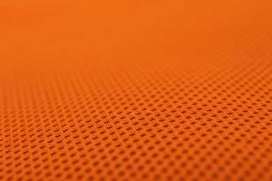 Photo of Texture of orange fabric as background, closeup