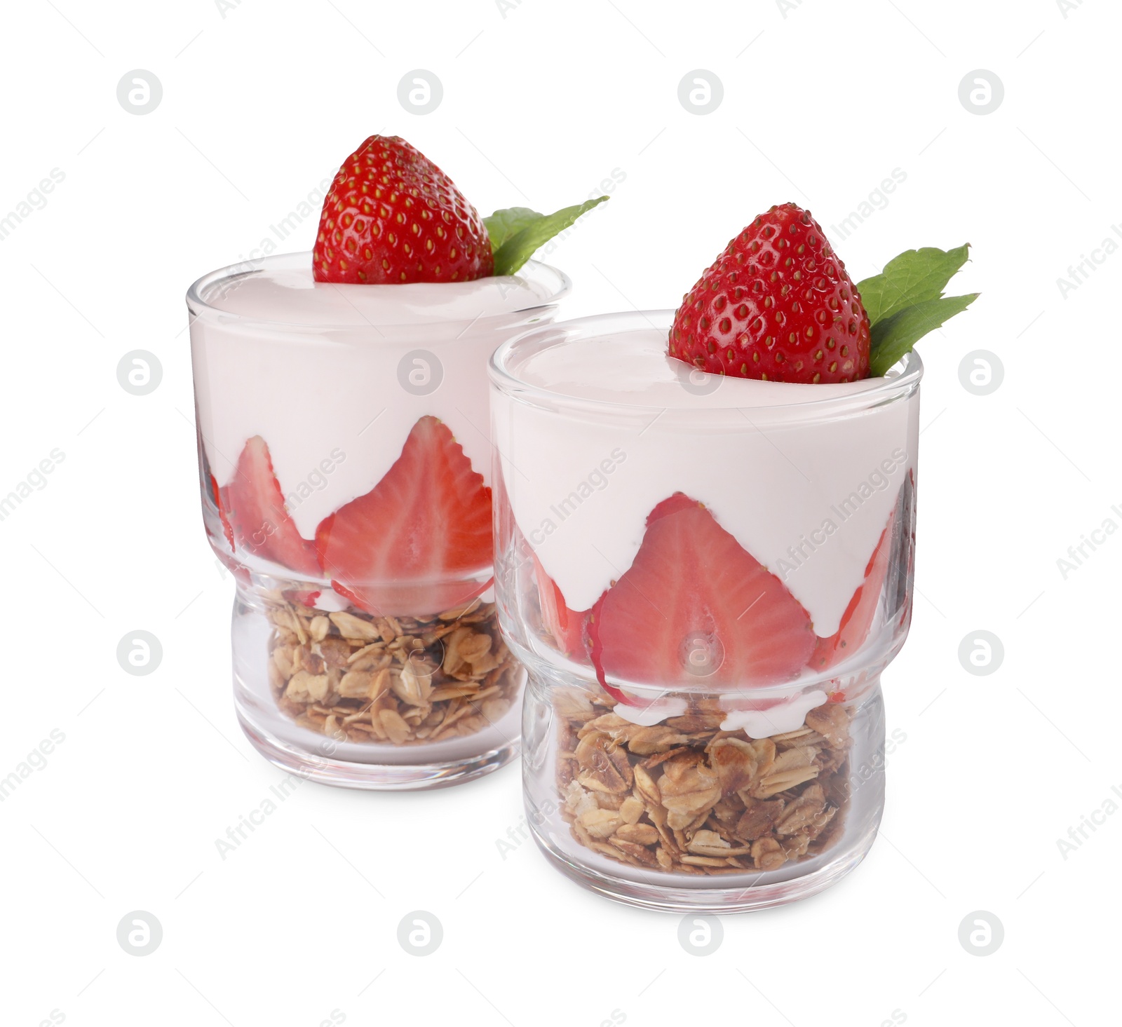 Photo of Glasses of tasty yogurt with muesli and strawberries isolated on white