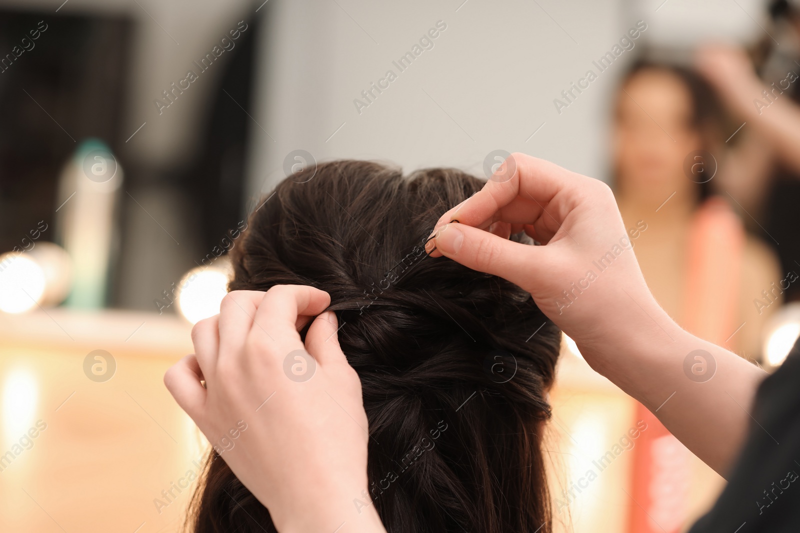 Photo of Hair styling. Professional hairdresser working with client indoors, closeup