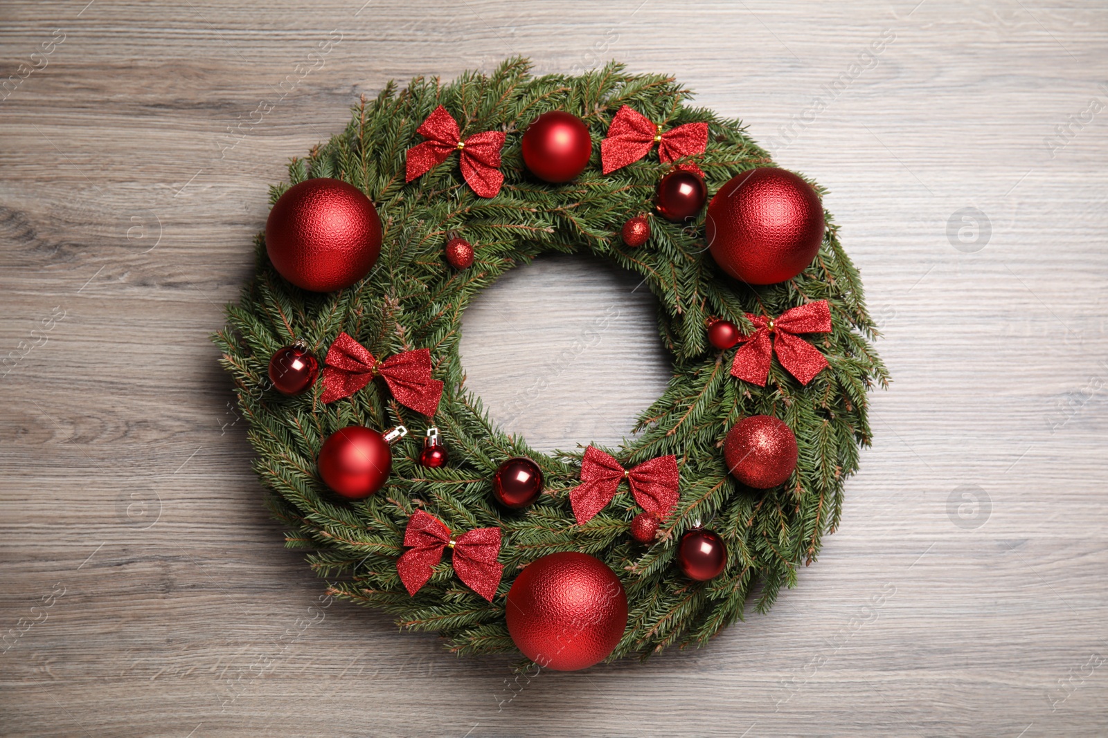 Photo of Beautiful Christmas wreath on wooden background, top view