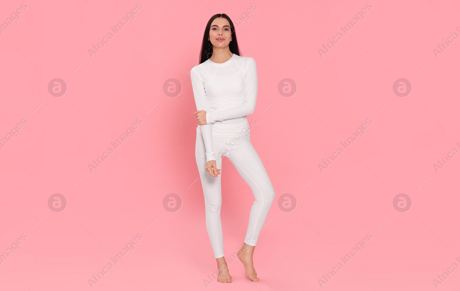 Photo of Woman in warm thermal underwear on pink background. Space for text