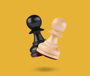 Wooden chess pawns in air on golden background
