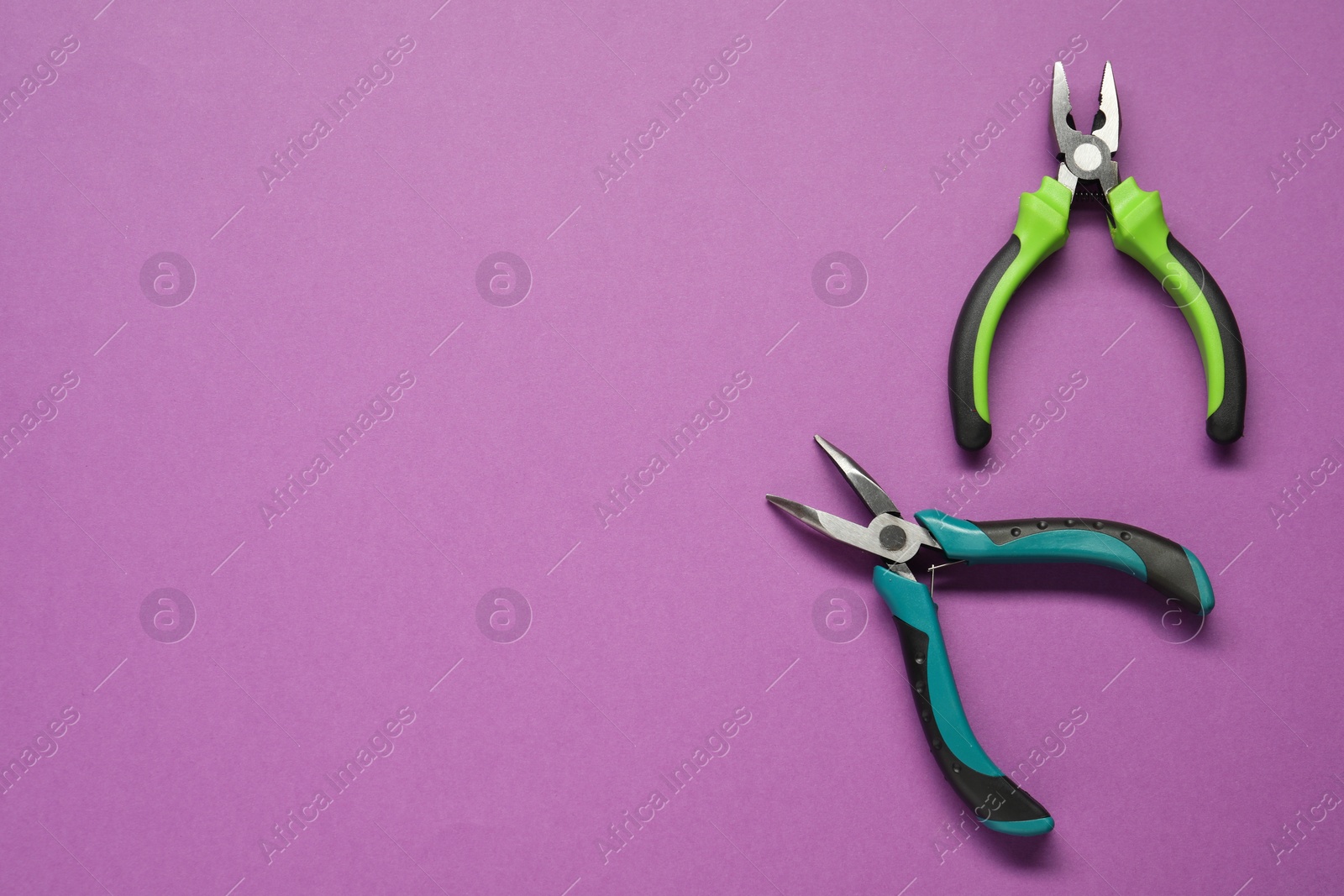 Photo of Pliers on purple background, flat lay. Space for text