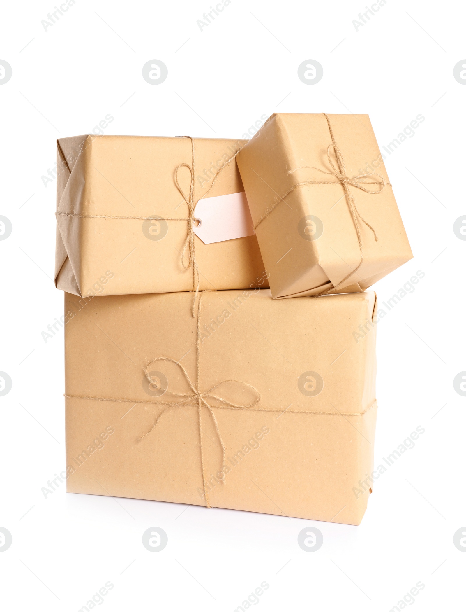 Photo of Stacked parcels wrapped in kraft paper on white background