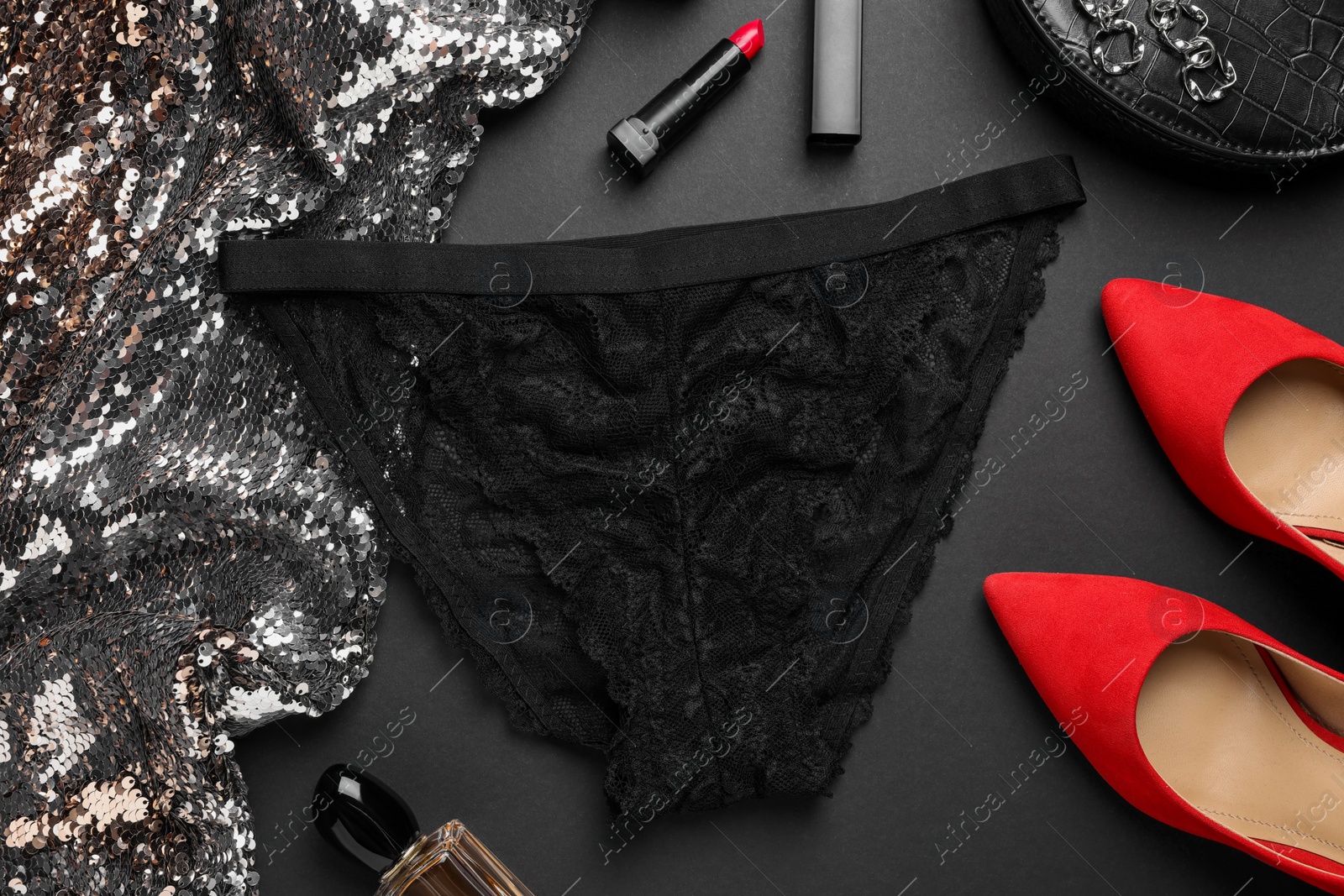 Photo of Flat lay composition with black women's underwear on dark grey background