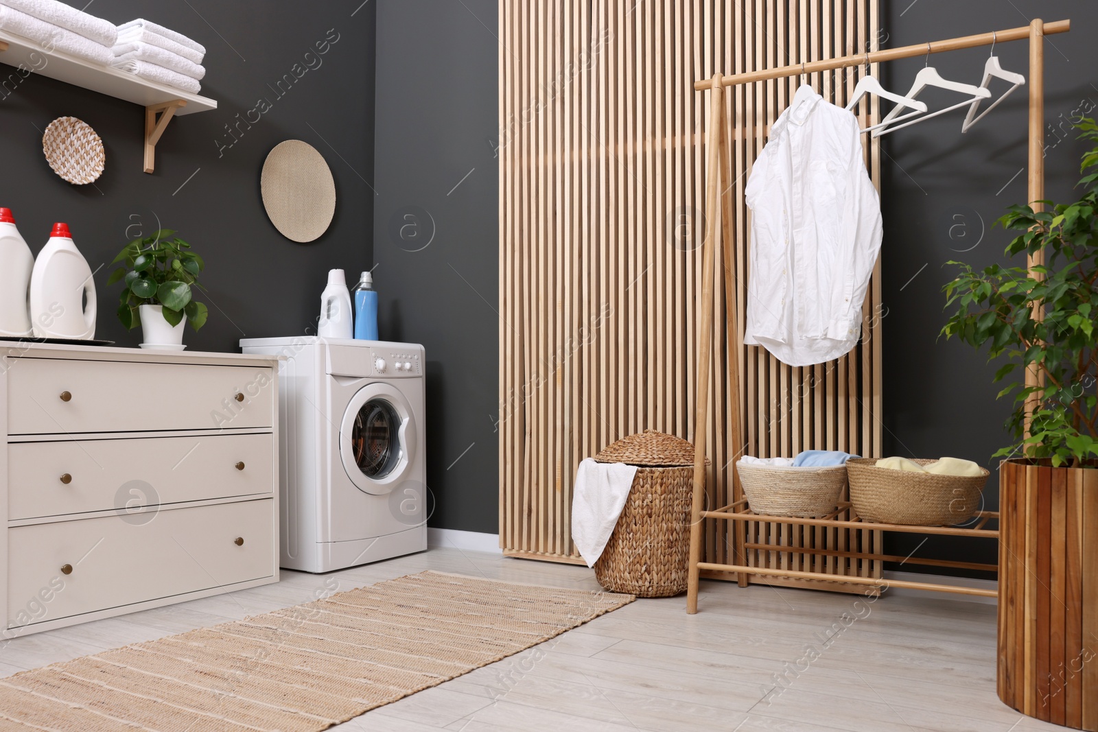 Photo of Laundry room interior with washing machine and furniture