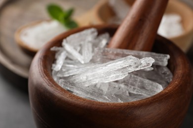 Photo of Menthol crystals in wooden mortar, closeup view