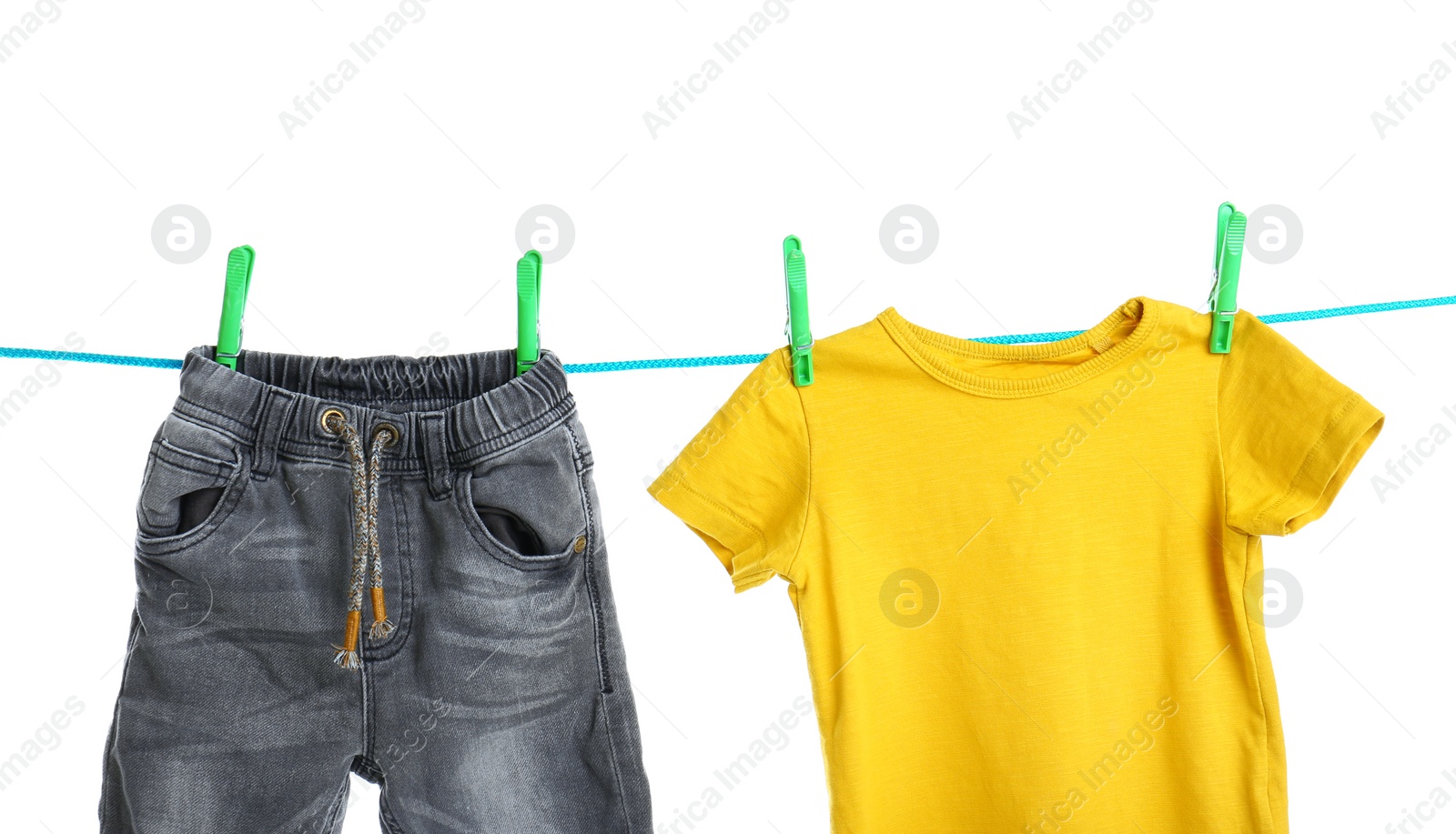 Photo of Child clothes on laundry line against white background