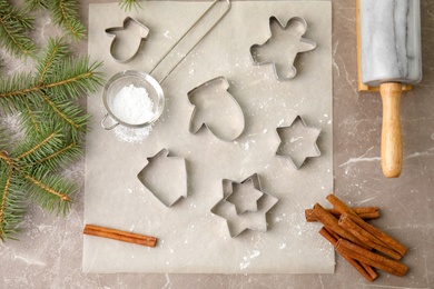 Photo of Composition with cutters for Christmas cookies on table, top view