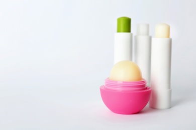 Hygienic lipsticks and balm on white background