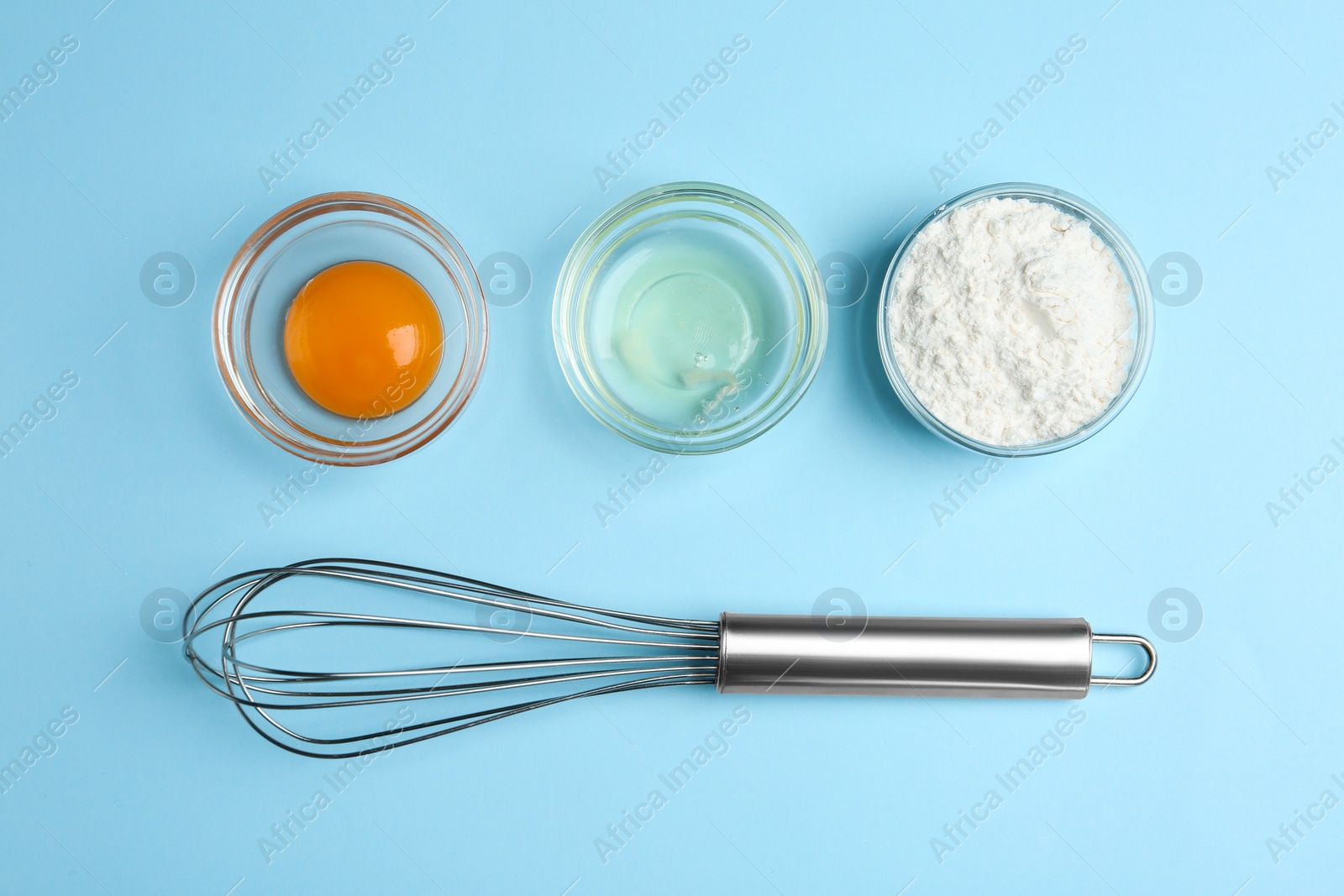 Photo of Flat lay composition with chicken egg and flour on light blue background