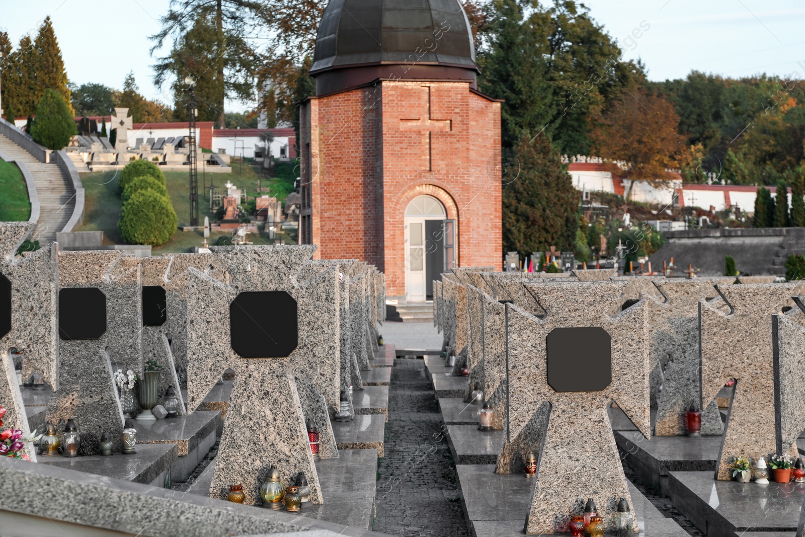 Photo of Many granite tombstones on cemetery. Funeral ceremony