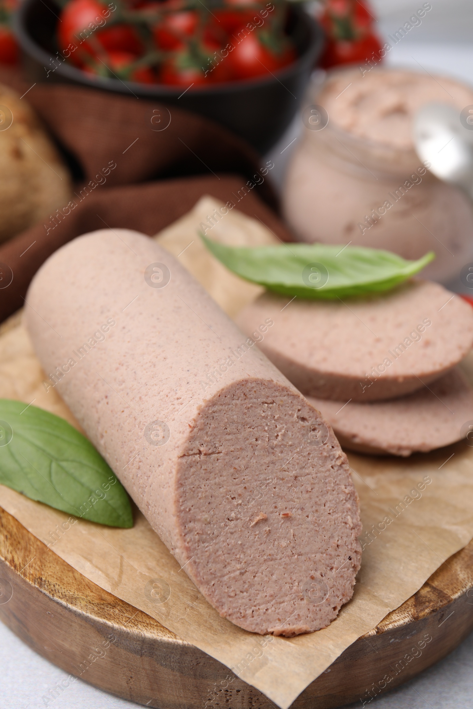 Photo of Delicious liver sausage on light grey table, closeup