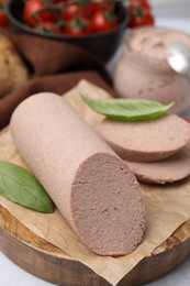 Photo of Delicious liver sausage on light grey table, closeup