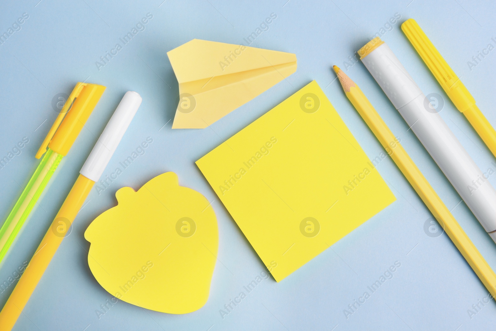 Photo of Flat lay composition with sticky notes and other school stationery on light blue background, space for text. Back to school