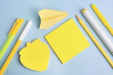 Photo of Flat lay composition with sticky notes and other school stationery on light blue background, space for text. Back to school