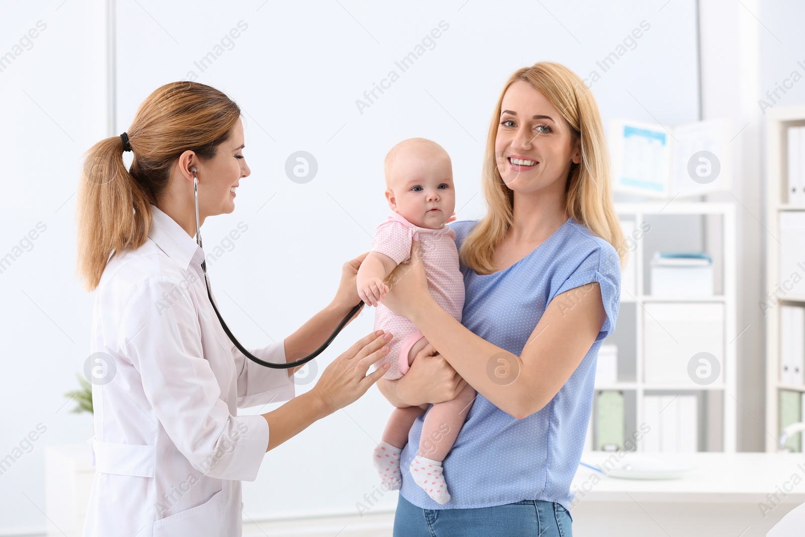 Photo of Woman with her baby visiting children's doctor in hospital