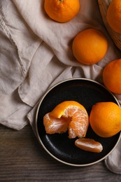 Photo of Many fresh ripe tangerines on wooden table, flat lay