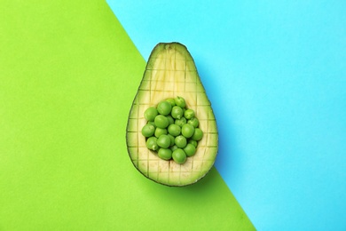 Photo of Composition with ripe avocado and green peas on color background, top view