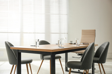 Photo of Simple office interior with large table and chairs