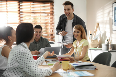 Photo of Team of professional designers working in office