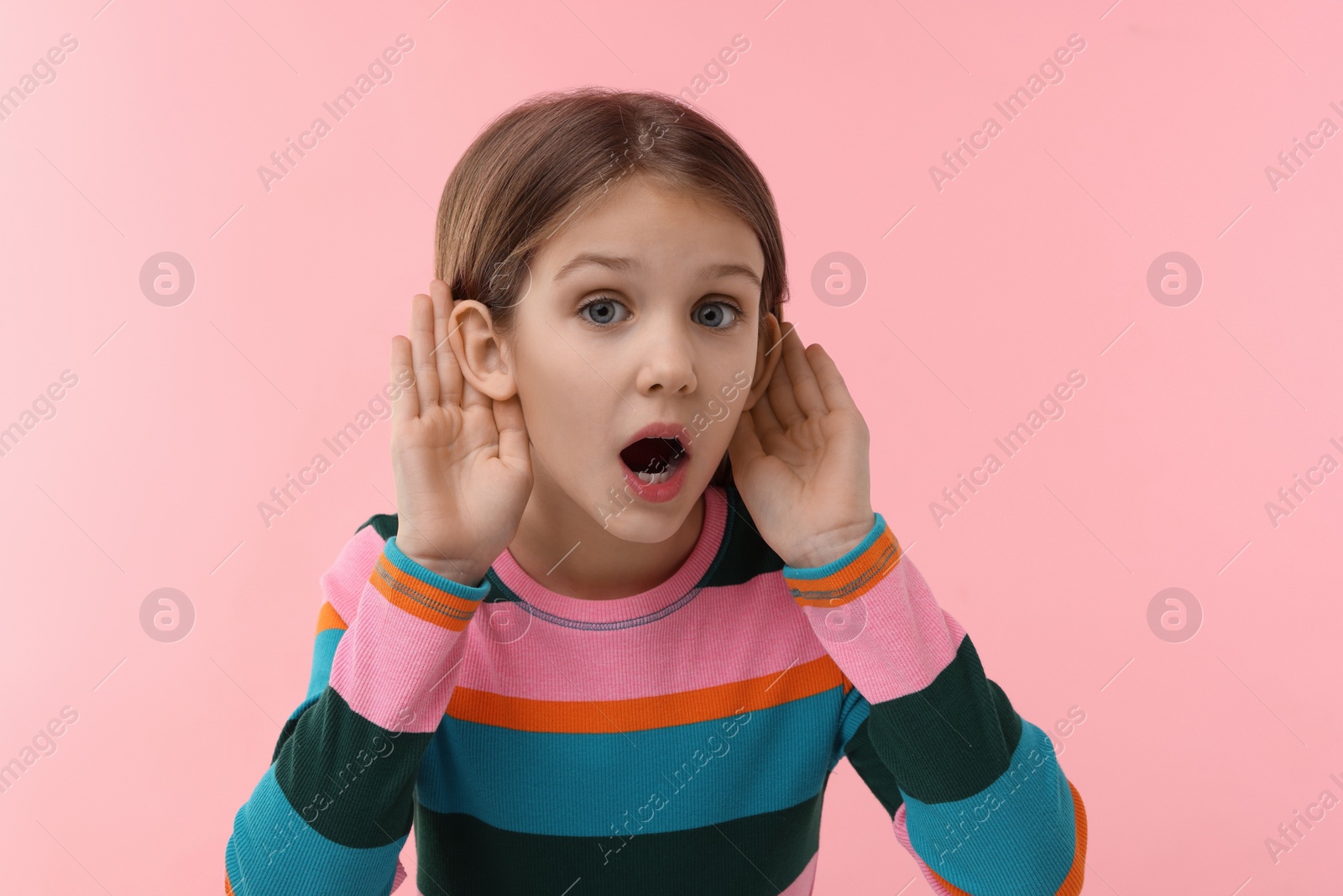 Photo of Little girl with hearing problem on pink background