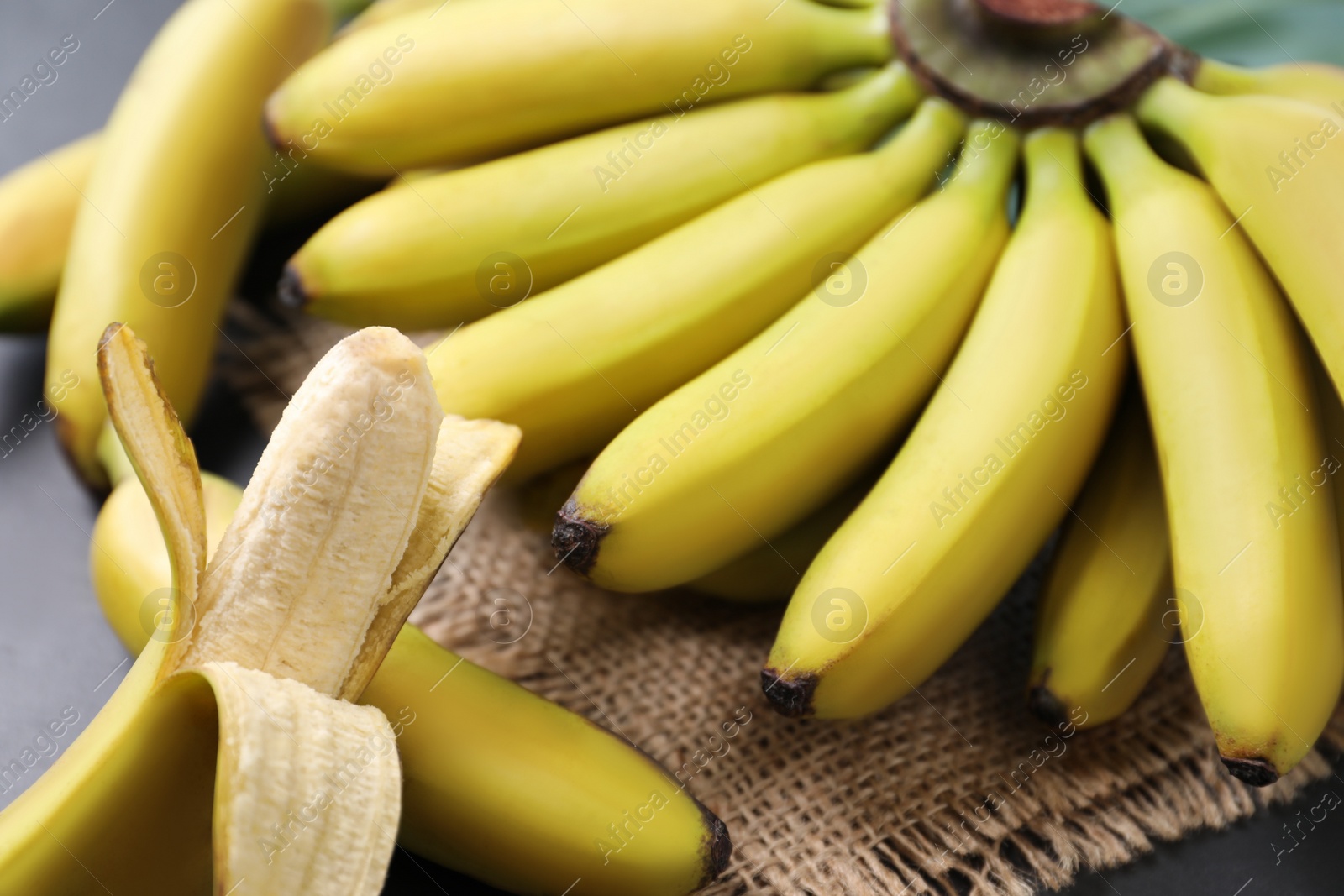 Photo of Tasty ripe baby bananas on table, closeup