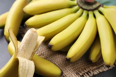 Photo of Tasty ripe baby bananas on table, closeup