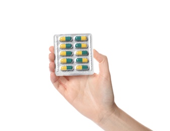 Photo of Woman holding pills in blister pack on white background, closeup