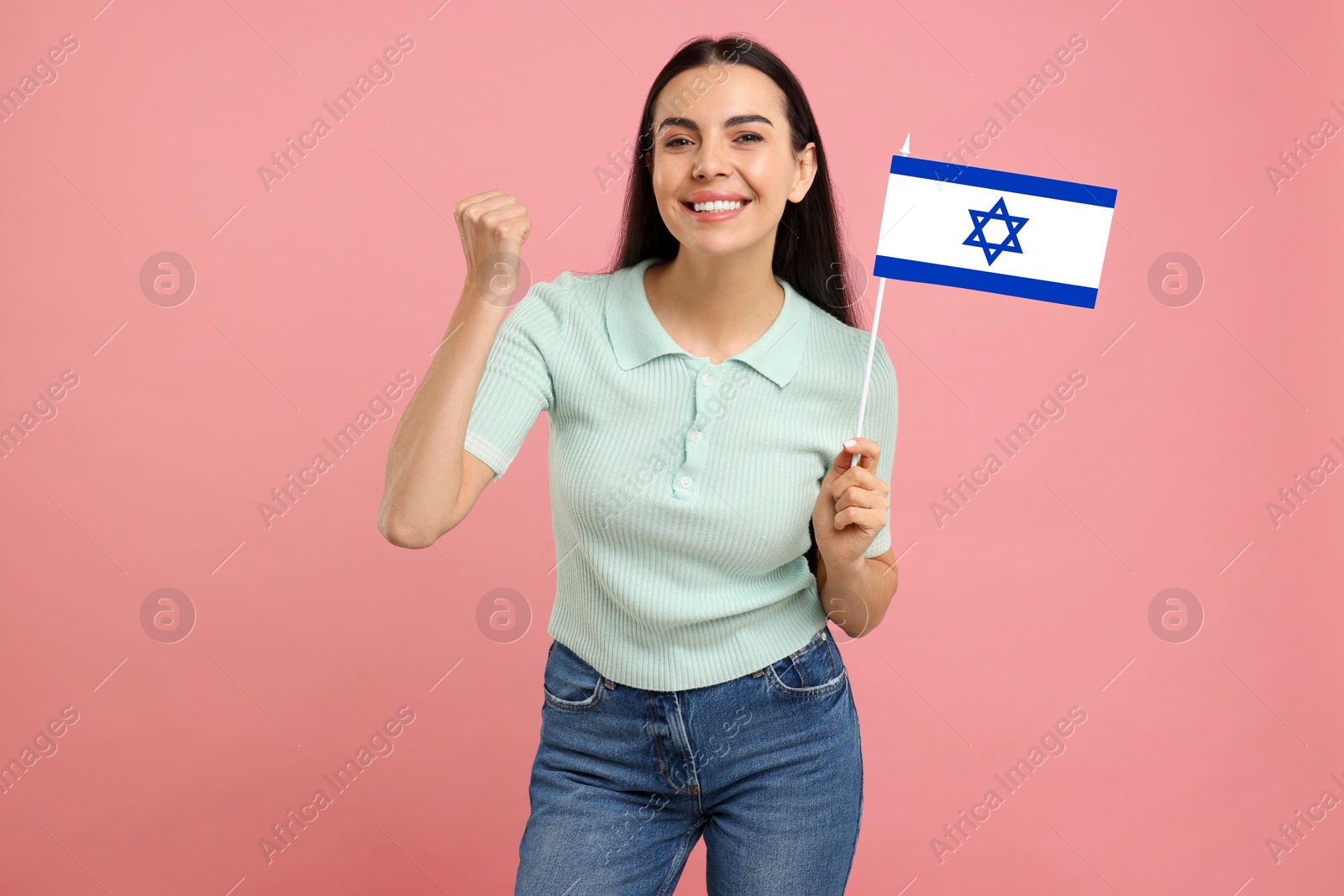 Image of Happy young woman with flag of Israel on pink background