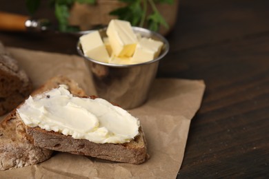 Photo of Tasty bread with butter on wooden table, closeup. Space for text