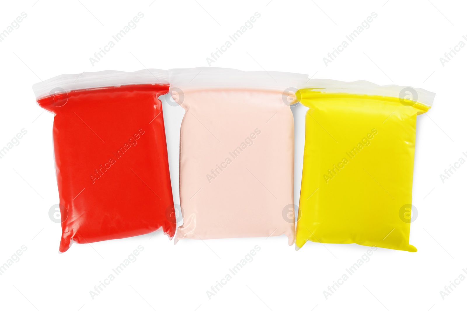 Photo of Packages of colorful play dough on white background, top view