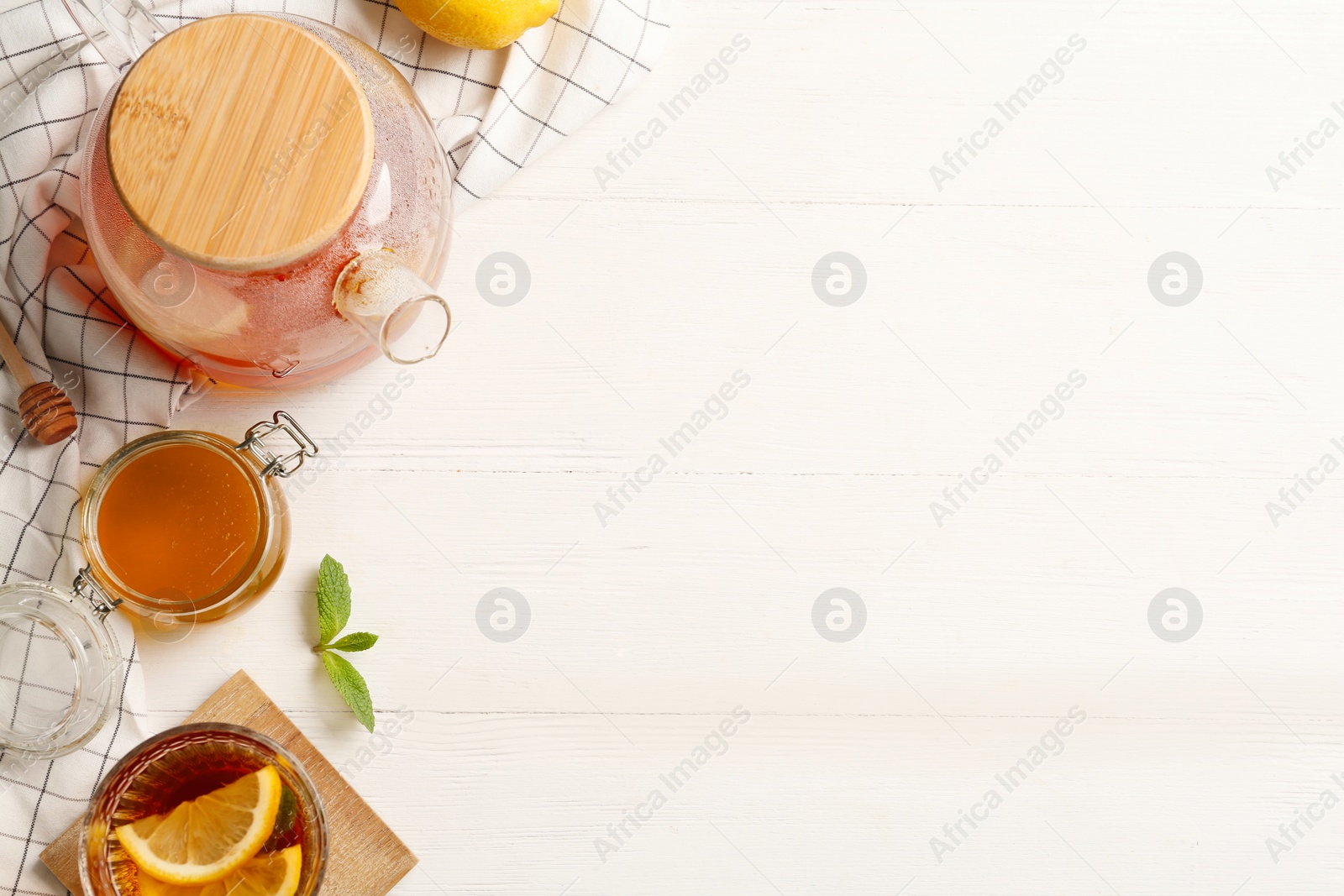 Photo of Flat lay composition with hot tea on white wooden table. Space for text