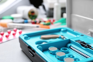 Photo of Hearing aid case on grey table. Medical objects