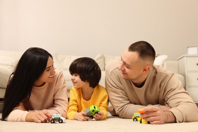 Happy family playing with toys together at home