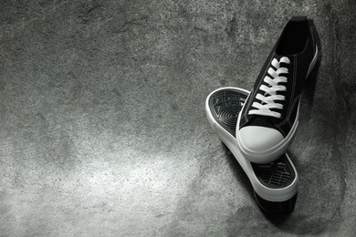Photo of Pair of stylish sneakers on grey background, space for text