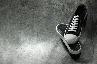 Pair of stylish sneakers on grey background, space for text