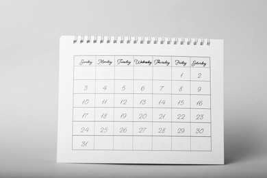 Photo of Paper calendar on grey background. Planning concept