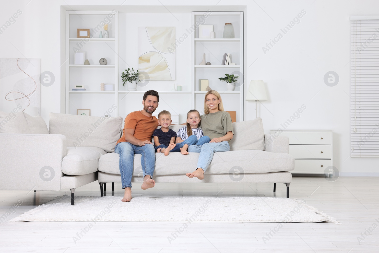 Photo of Portrait of happy family with children on sofa at home