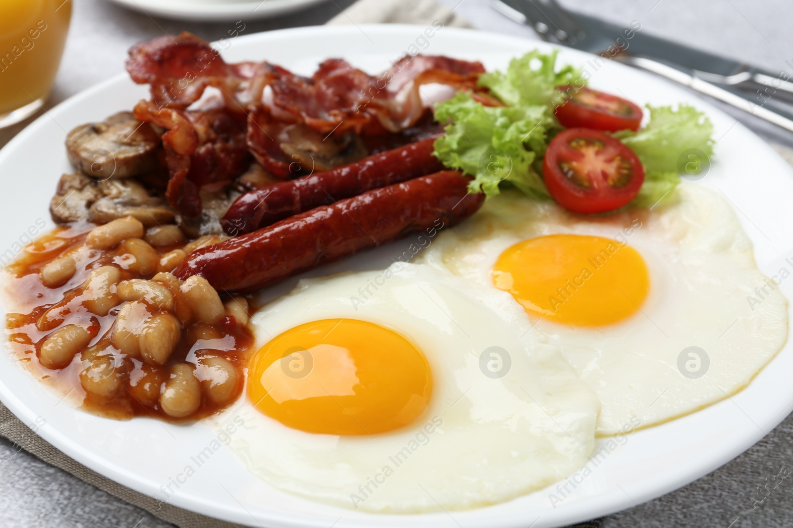 Photo of Delicious breakfast with sunny side up eggs on light table, closeup