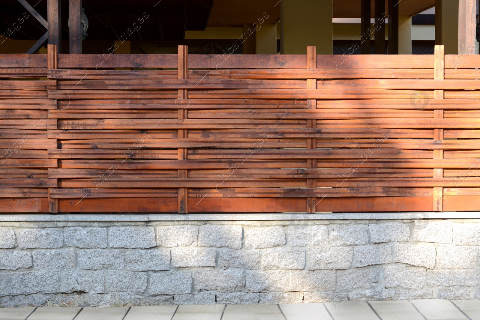 Photo of Wooden fence near house on sunny day outdoors