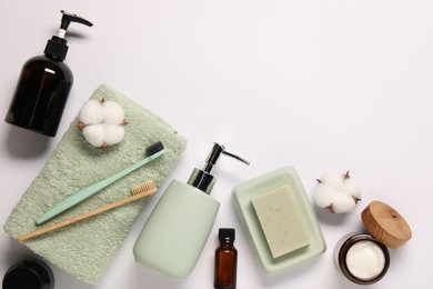 Bath accessories. Different personal care products and cotton flowers on white background, flat lay with space for text