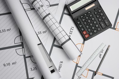 Construction drawings, ruler, pencil and calculator on house plan, flat lay. Architect workspace