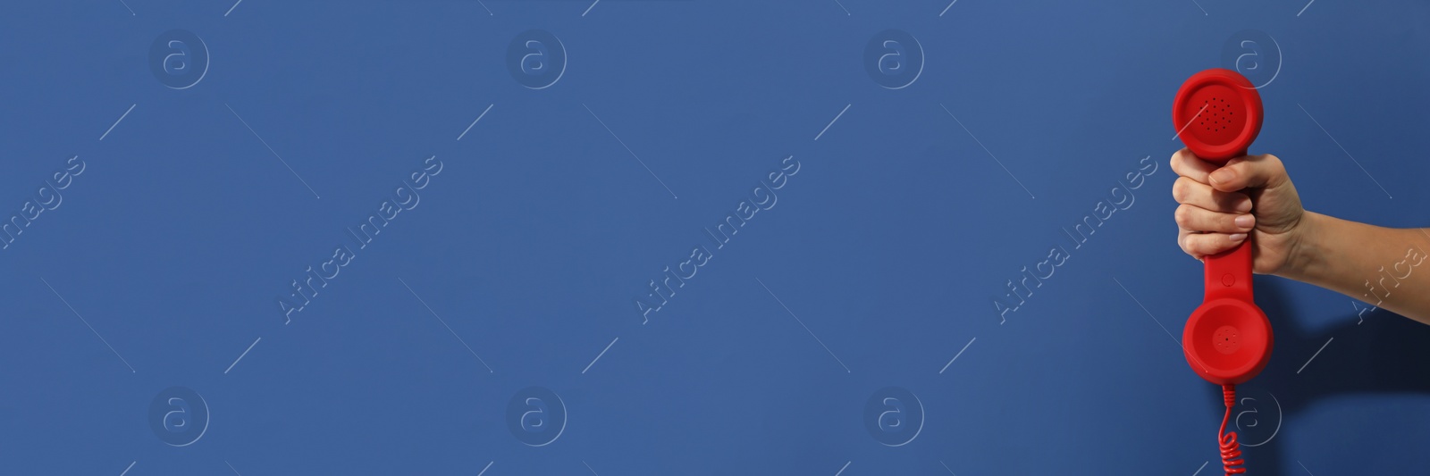 Image of Hotline service. Woman with telephone receiver and space for text on blue background, banner design