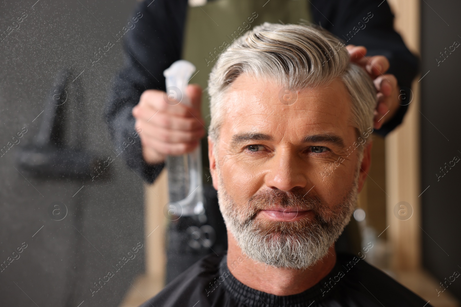 Photo of Hair styling. Professional hairdresser working with client in barbershop, closeup