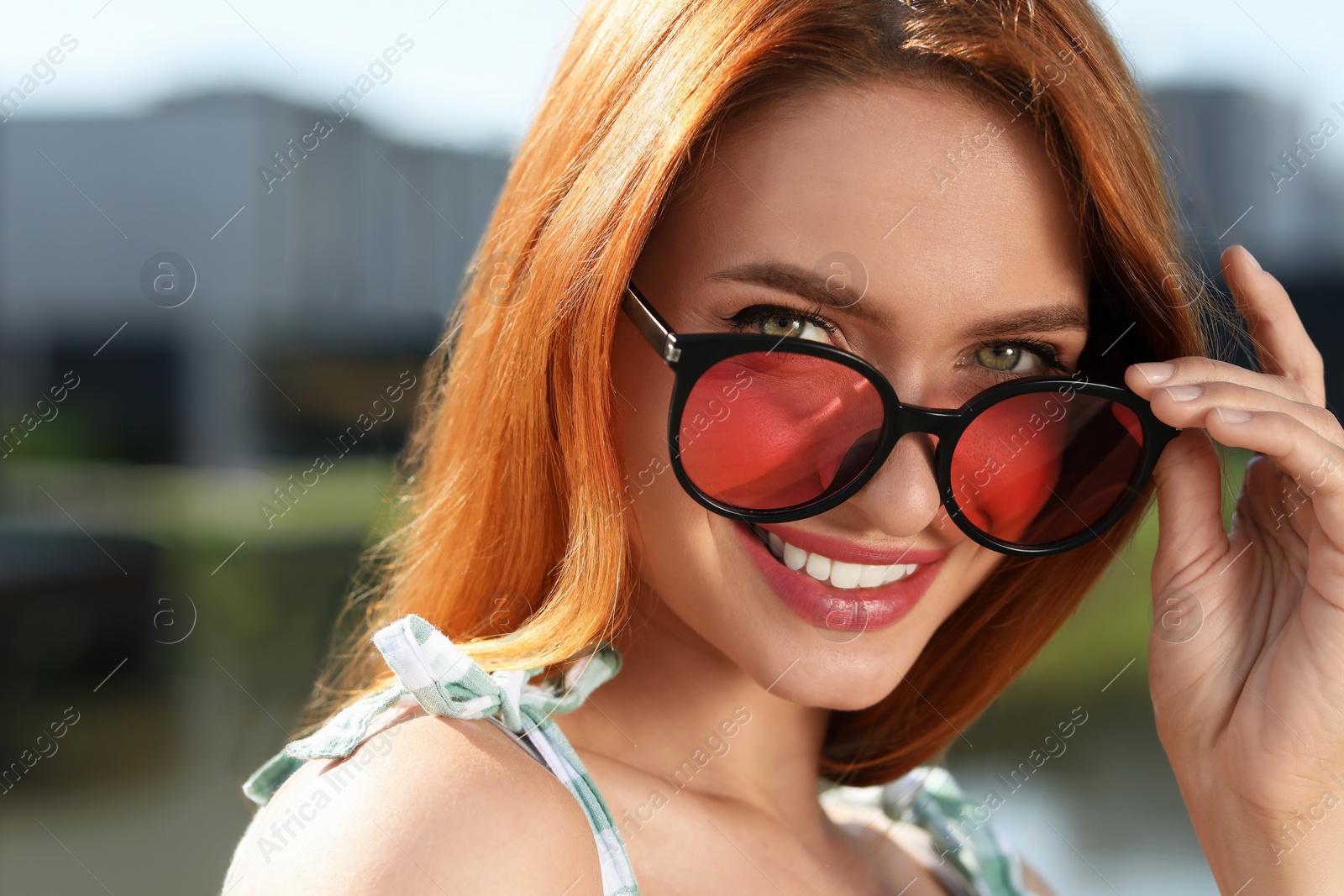 Photo of Beautiful smiling woman in sunglasses outdoors, space for text