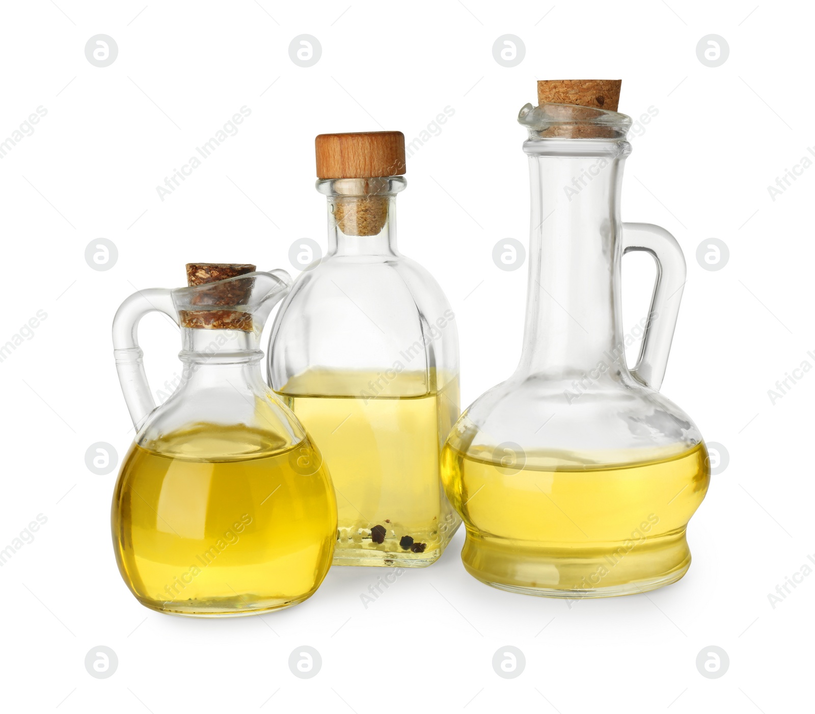 Photo of Vegetable fats. Glassware of different cooking oils isolated on white